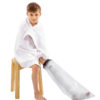 Young boy sitting on a stool in a white towel with a LimbO Child’s Full Leg Cast Waterproof Protector on his left leg
