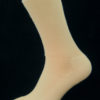 A beige cotton Prosox Ankle Length Sock that has been placed on a mannequin leg to demonstrate the appearance when worn on an actual leg.