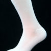 A white cotton Prosox Ankle Length Sock that has been placed on a mannequin leg to demonstrate the appearance when worn on an actual leg