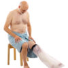Gentleman sitting down in a blue towel wearing a half leg LimbO Waterproof protector on his left leg